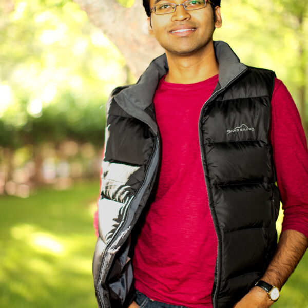 a fellow classmate looking taking a casual, sunlit portrait