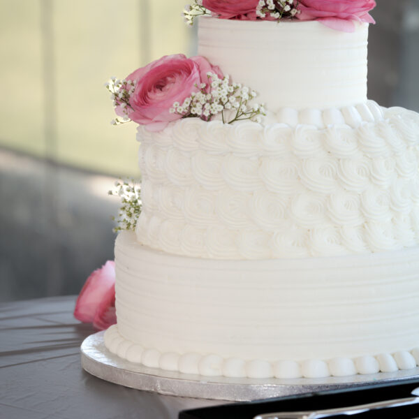 three-tier wedding cake waiting to be cut