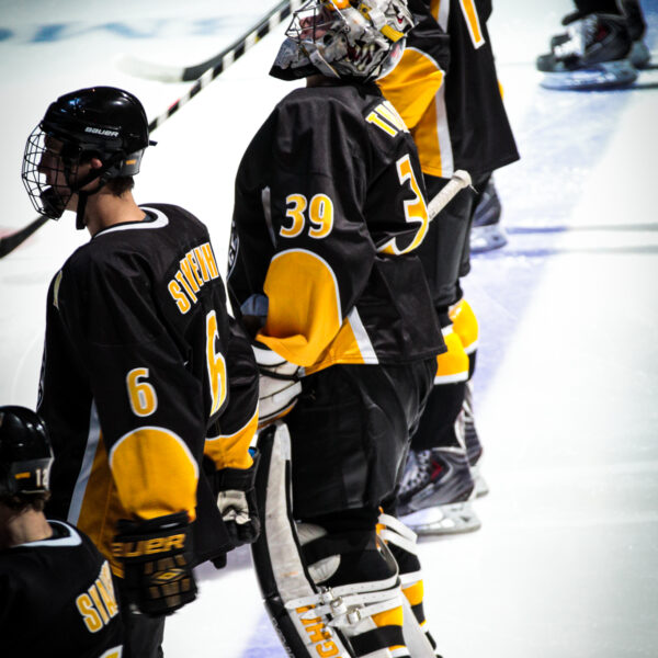 hockey goalie praying before a game